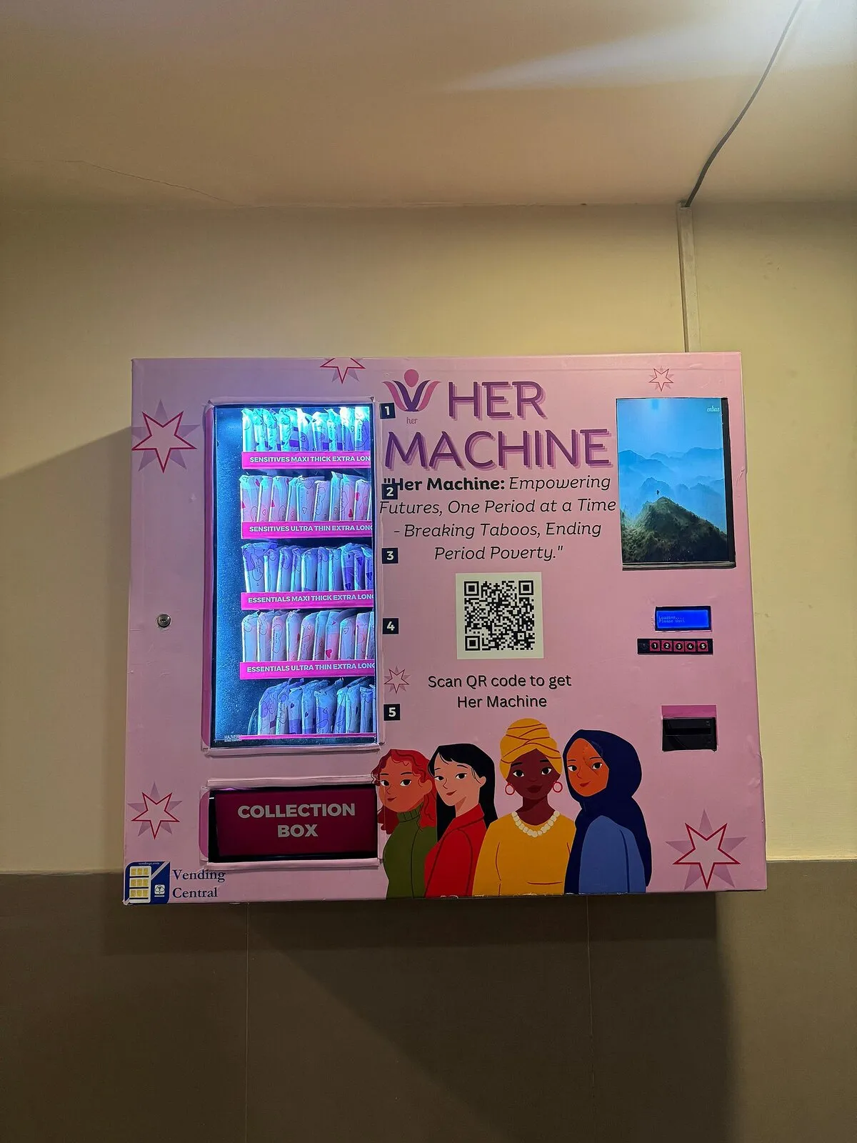 A wall-mounted pad vending machine with a colourful front panel and a collection box